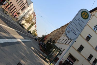 Im Vordergrund des Fotos sieht man ein Haltestellenschild mit der Aufschrift Kurt-Tucholsky-Platz, kurz dahinter steht das Haltestellenhäuschen (Foto: Ministerium der Finanzen LSA)