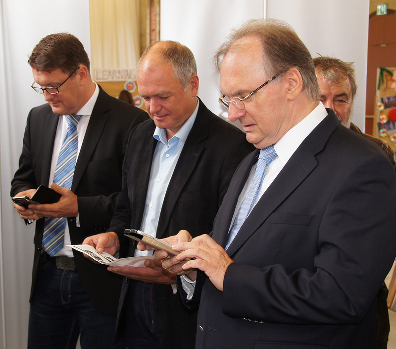 Das Foto zeigt rechts Ministerpräsident Haseloff und weitere Gäste der Abschlussveranstaltung, die sich die von den Eurocampern gestaltete Handy-App gleich herunterluden.