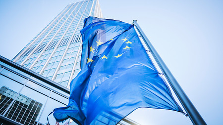 Flagge der Europäischen Union vor einem Hochhaus.