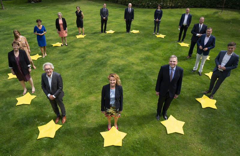 Foto der Mitglieder der EMK auf grünem Rasen und in einem Kreis formiert. Vor jeder Europaministerin und Europaminister liegt ein großer gelber EU-Stern.